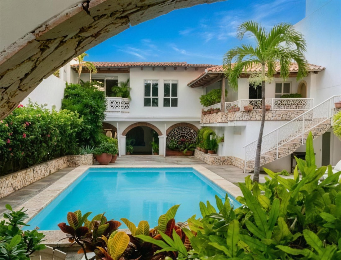 Pool, arches and palms in the courtyard of a colonial house in Cartagena